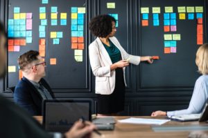 Latina Woman manager updating her team on a project